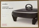 New, Open Box - Cooks Black 12'' Nonstick Electric Skillet, Glass Cover. Fixed Price $30.00.